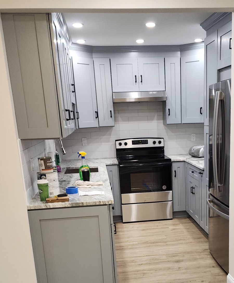 Kitchen with new granite countertops and subway tile backsplash, gray shaker cabinets and stainless appliances