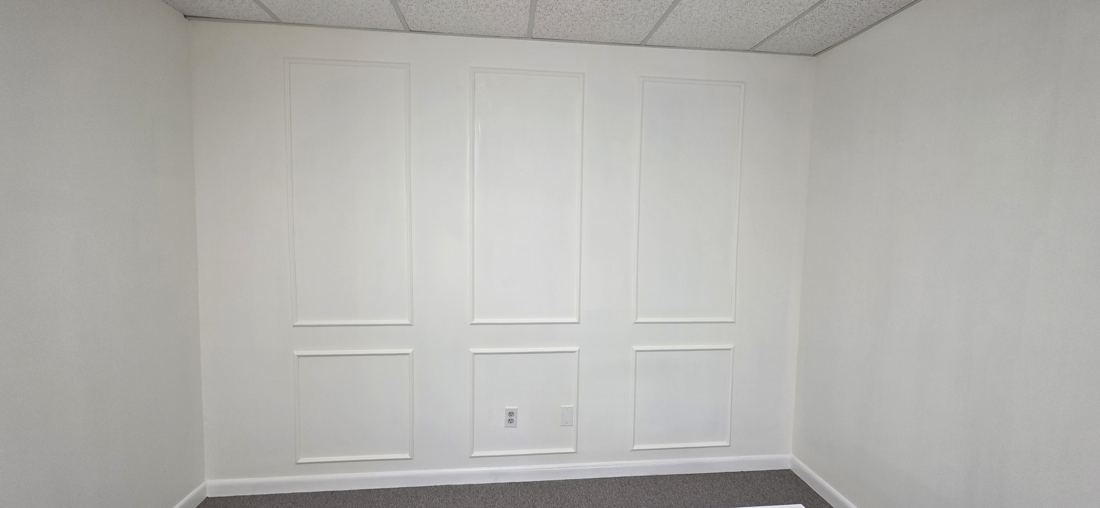 White office wall with rows of picture-frame panel moulding